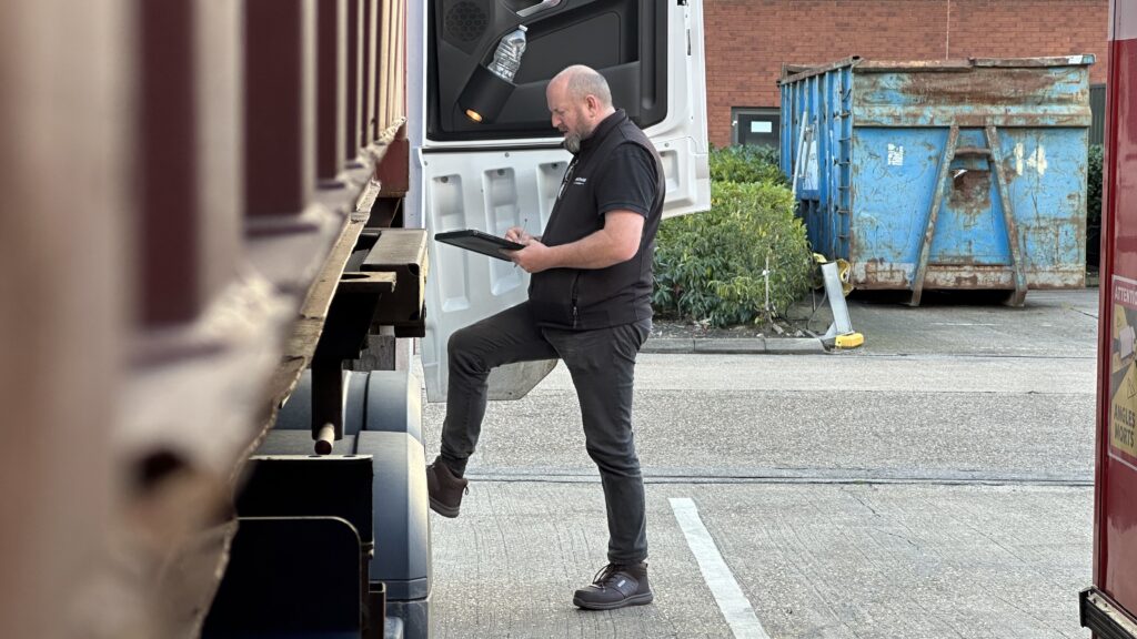 Worker doing the paperwork close to the lorry